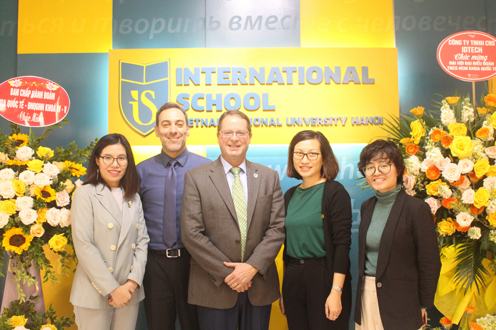 Keuka College's Dean of International Programs, Asia Gary Giss, second from left, and Vice President for Enrollment Management &amp; Student Development Mark Petrie, center, poses with partners during a visit to Vietnam National University in Hanoi, Vietnam, in December. (Photo provided)