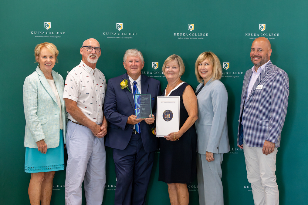 The 2025 Donald and Corrine Stork Award for Community Service winners, Stacy and Chris Wyant, center, pose with, from left, Peggy Stork Havens and Steve Stork (Donald and Corrine Stork's children), Keuka College President Amy Storey, and College Workforce Development Specialist Steve Griffin.