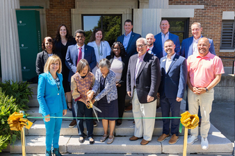 Janet Chin, second from left, and Susan Chin prepare to cut the ribbon to formally dedicate the Mary Ikeda Chin ’50 Health Assessment Suite at Keuka College on Friday, Aug. 22. Joining them in the front row are, from left, President Amy Storey, state Sen. Tom O’Mara, Keuka College Vice President for Advancement Rich Basler, and CEO of the Finger Lakes Economic Development Center Steve Griffin.